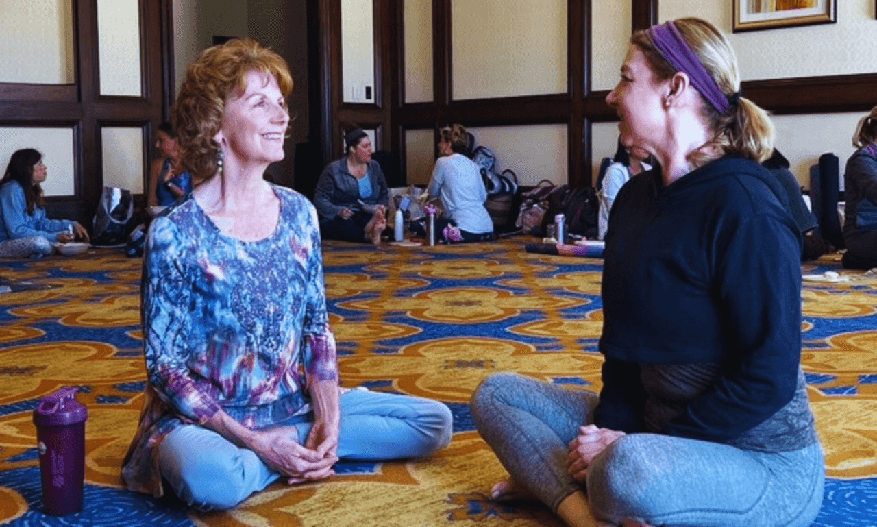 Cindy Baez connecting with a woman at a retreat